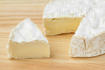 Fototapeta na wymiar camembert soft cheese on wood background 