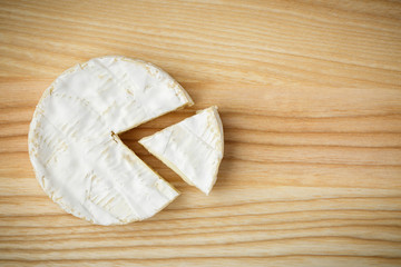 camembert soft cheese on wood background 