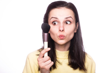 attractive girl does makeup, makeup brush