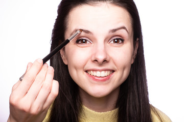 Obraz premium attractive young woman doing makeup