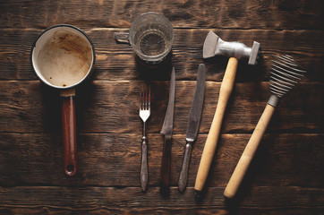 Old kitchen utensils on a rural kitchen table background.