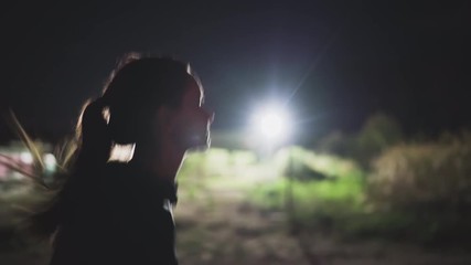 Young woman running by night in the stadium, fitness and workout wellness concept