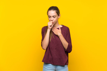 Young woman over isolated yellow background is suffering with cough and feeling bad