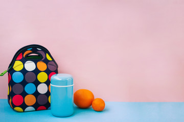 snack on a break with a lunchbox. colorful handbag, blue thermos, orange, tangerine. place for...