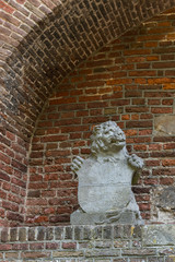 sculpture of lion against brick wall, in gate called Broerderpoort. Kampen, The Netherlands_-4