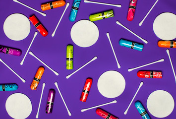 Concept of the menstrual period. Women's Protection of Hygiene. Multicolored flower swabs with colorful petals on a blue background