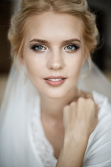 Closeup portrait of a bride's face. She is looking at the camera.
