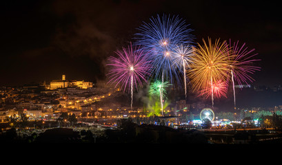 Panoramic view of the city of Coimbra, Portugal, with the firework show during the city festivities in 2019.