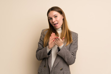 Young business woman applauding after presentation in a conference