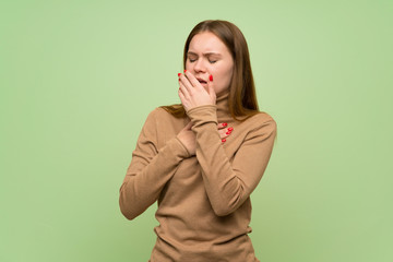 Young woman with turtleneck sweater is suffering with cough and feeling bad