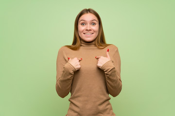 Young woman with turtleneck sweater with surprise facial expression