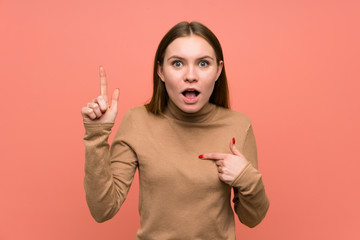 Young woman over colorful background with surprise facial expression