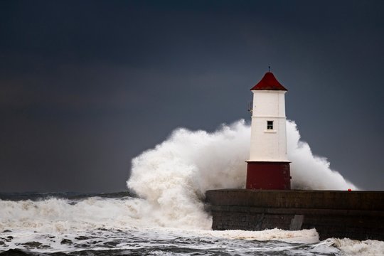 Berwick Lighthouse with strong surf and dark cloudy sky, Berwick-upon-Tweed, Newcastle upon Tyne, Northumberland, Great Britain