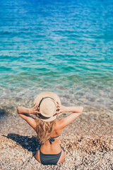 Fototapeta na wymiar Young beautiful woman relaxing at european beach