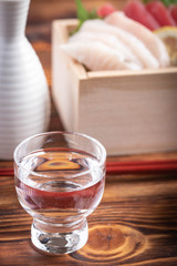 japanese sake and sashimi in wooden box, masu