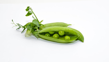 Green peas on a white background. Fresh harvest.