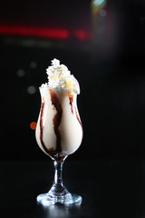 Milk non-alcoholic cocktail with coffee syrup. The concept of making a cocktail.