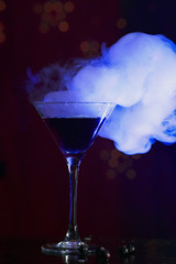 cocktail and smoke on a dark background