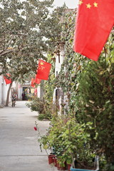Obraz na płótnie Canvas Backstreet with chinese flags-rear area of the Sunday Market. Hotan-Xinjiang-China-0121