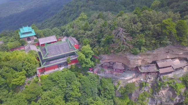 Aerial landscape from backside Nanyan Palace. Main palace and construction of secondary temples build directly on the rock. Part of them are hanging on the cliff. Wudang Shan Mountains, Hubei province