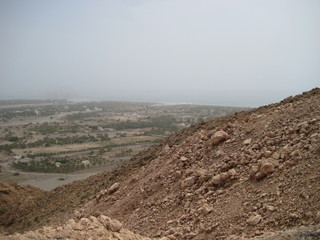 Middle East or Africa, picturesque bare mountain range and a large sandy valley desert landscapes landscape photography. Horizontal frame oasis