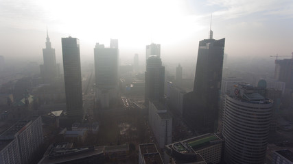 Fototapeta na wymiar Aerial view. Flying in a foggy morning in the direction of the skyscrapers in the center of Warsaw.