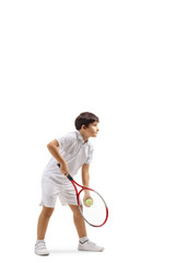 Boy serving a tennis ball