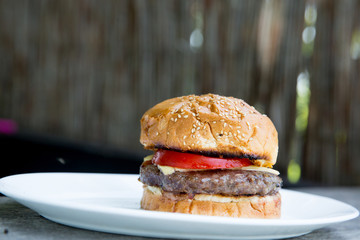 fresh tasty burger on wooden background