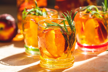 Glasses with drops of sweet peach iced tea