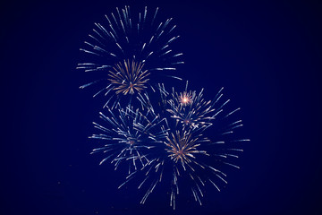 Cheap bright sparkling fireworks, blue and golden color, on the night sky, background texture