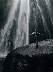 Obraz premium A person admirnig the beauty of Skogafoss waterfall located in Iceland