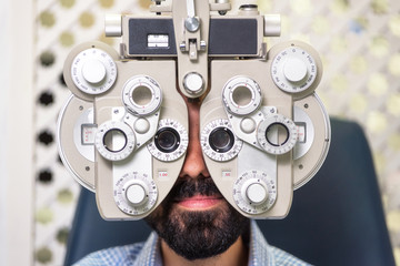  Patient in modern ophthalmology clinic checking the eye vision .