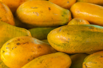 Papaya in the market. Fruit of orange pulp with countless small seeds. Exotic tropical fruit