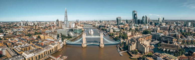 Tower Bridge in London, the UK. Bright day over London. Drawbridge opening. One of English iconic...