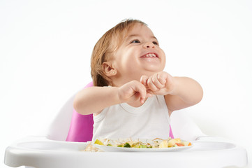 Portrait of baby playing with food