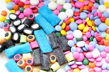 Licorice candy and chocolate dragee in a multi-colored glaze. Texture, background.