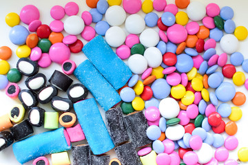 Licorice candy and chocolate dragee in a multi-colored glaze. Texture, background.