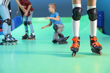 Naklejka premium Family having fun at roller skating rink, closeup