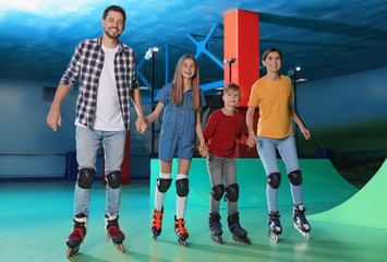 Happy family having fun at roller skating rink