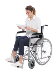 Young woman in wheelchair using tablet isolated on white