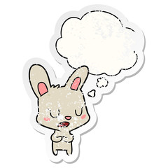 cartoon rabbit talking and thought bubble as a distressed worn sticker