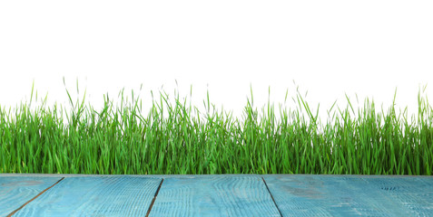 Blue wooden deck and green grass isolated on white