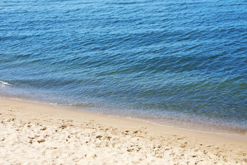 Sandy beach near sea on sunny day