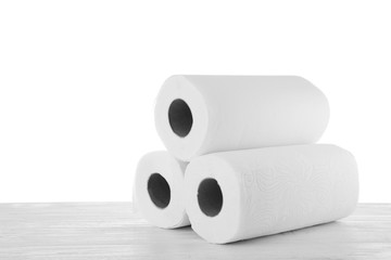 Rolls of paper towels on grey stone table against white background, space for text