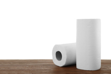 Rolls of paper towels on wooden table against white background, space for text