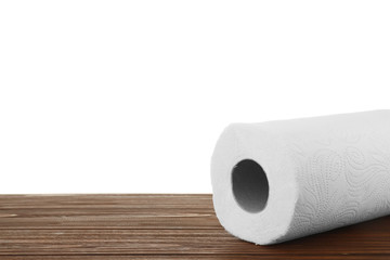 Roll of paper towels on wooden table against white background, space for text