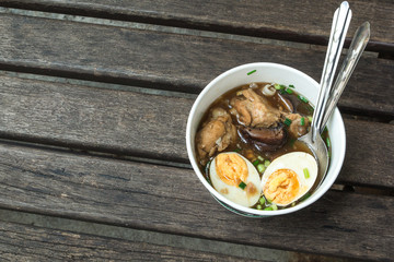 One Chinese roll noodle soup with boiled egg on the wood table