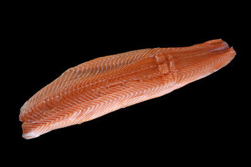 Raw salmon fillet over black background