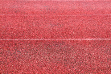 Red rubber treadmill. Close-up. Horizontal view. Background. Texture.