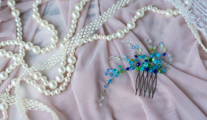 Wedding background with pearls and hair accessories on pink background